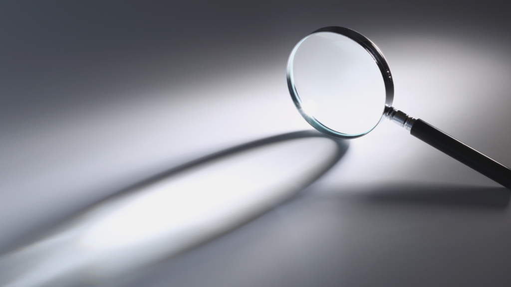 Magnifying glass on a grey background