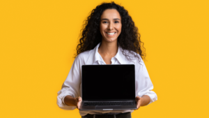 Woman holding a laptop with a yellow background